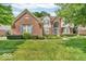 Charming two-story brick home with manicured lawn, lush shrubbery and beautiful curb appeal at 5865 Osage Dr, Carmel, IN 46033