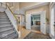 Sun-filled foyer with hardwood floors, staircase and open view to a den at 5865 Osage Dr, Carmel, IN 46033