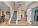 Two-story foyer with hardwood floors, staircase and classic trim details at 5865 Osage Dr, Carmel, IN 46033