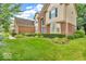 Charming two-story brick home with manicured landscaping, mature shrubs, and a well-maintained lawn at 5865 Osage Dr, Carmel, IN 46033