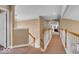 Upstairs hallway showcasing the home's natural light, carpeted flooring, and railing at 5865 Osage Dr, Carmel, IN 46033