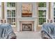 Cozy fireplace is the centerpiece of this bright living room with window views at 5865 Osage Dr, Carmel, IN 46033