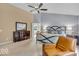 Bright main bedroom featuring a ceiling fan, en-suite bath, and neutral paint scheme at 5865 Osage Dr, Carmel, IN 46033