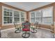 Light-filled sunroom featuring large windows, tile flooring, and comfortable seating at 5865 Osage Dr, Carmel, IN 46033