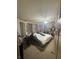 Comfortable bedroom features a ceiling fan, large bed and functional decor at 5954 Honeywell Dr, Indianapolis, IN 46236