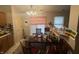 The dining room includes a wooden table, a chandelier and bar seating area at 5954 Honeywell Dr, Indianapolis, IN 46236