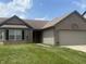Charming single-story home with brick and siding, featuring an attached garage and front lawn at 5954 Honeywell Dr, Indianapolis, IN 46236