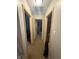 Hallway between rooms with tan walls and wood trim at 5954 Honeywell Dr, Indianapolis, IN 46236