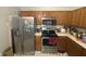 Functional kitchen with stainless steel appliances and wooden cabinets at 5954 Honeywell Dr, Indianapolis, IN 46236