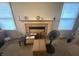 Living room featuring a traditional fireplace and windows for natural light at 5954 Honeywell Dr, Indianapolis, IN 46236