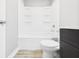 Clean bathroom featuring a tub-shower, toilet, and dark vanity, creating a functional space at 602 W 34Th St, Anderson, IN 46013