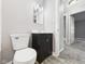 Bathroom with a white toilet, black vanity, and a mirror, with view into bedroom with plush carpeting at 602 W 34Th St, Anderson, IN 46013