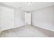 A light-filled bedroom with neutral walls, carpet and two white doors, one a closet and one an entrance at 602 W 34Th St, Anderson, IN 46013