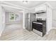 Open concept view of the kitchen with stainless steel appliances and wood look vinyl flooring at 602 W 34Th St, Anderson, IN 46013