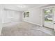 Bright living room features neutral paint and carpeting at 602 W 34Th St, Anderson, IN 46013