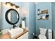 Nicely decorated half-bathroom features modern fixtures, wood countertop, and blue paint at 6126 Navy Cir, Indianapolis, IN 46221