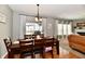 Bright dining room with wooden table, pendant lighting, and view of the backyard deck at 6126 Navy Cir, Indianapolis, IN 46221