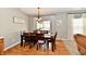 Bright dining room with wooden table, pendant lighting, and sliding door access to back deck at 6126 Navy Cir, Indianapolis, IN 46221