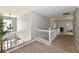 Upstairs hallway featuring carpet, neutral paint, and white railing to the lower level at 6126 Navy Cir, Indianapolis, IN 46221