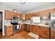 Well-equipped kitchen features stainless steel appliances, wooden cabinets, and ample counter space at 6126 Navy Cir, Indianapolis, IN 46221