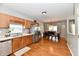 Open floor plan of kitchen and dining area features stainless steel appliances and wooden cabinets at 6126 Navy Cir, Indianapolis, IN 46221