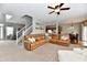 Spacious living room with staircase, featuring a sectional sofa and open layout at 6126 Navy Cir, Indianapolis, IN 46221