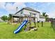 A great backyard with a wooden playset, slide and climbing area, next to the covered deck at 6126 Navy Cir, Indianapolis, IN 46221