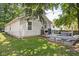 Large, grassy backyard features a wooden deck with seating ideal for entertaining at 6142 Evanston Ave, Indianapolis, IN 46220