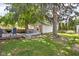 Landscaped backyard featuring a deck with dining and recreational space under mature trees at 6142 Evanston Ave, Indianapolis, IN 46220