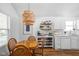 Charming dining area features a wooden table, wicker chairs, and a unique wicker chandelier at 6142 Evanston Ave, Indianapolis, IN 46220