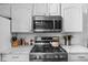 Kitchen features a stainless steel microwave, oven, and range top with quartz countertops at 6142 Evanston Ave, Indianapolis, IN 46220