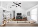 Open concept living room featuring hardwood floors, built-in shelving, and a high ceiling at 6142 Evanston Ave, Indianapolis, IN 46220