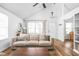 Bright living room with vaulted ceiling, hardwood floors, and neutral decor with a cozy couch at 6142 Evanston Ave, Indianapolis, IN 46220