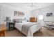 Bright bedroom features a queen bed with striped throw, neutral walls and stylish decor at 6142 Evanston Ave, Indianapolis, IN 46220