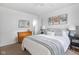 Bright bedroom features a queen bed with striped throw, neutral walls and stylish decor at 6142 Evanston Ave, Indianapolis, IN 46220