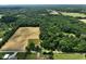 Beautiful aerial view of the property's home, outbuilding, farmland, and green space at 6208 S 200 W, Trafalgar, IN 46181