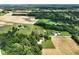 Scenic aerial shot of a property featuring open fields, pond, and surrounding lush greenery at 6208 S 200 W, Trafalgar, IN 46181