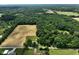 Gorgeous aerial view of the property's home, outbuilding, farmland, and green space at 6208 S 200 W, Trafalgar, IN 46181