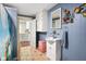 Compact bathroom features a pedestal sink, toilet, and tiled floors at 6208 S 200 W, Trafalgar, IN 46181