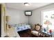Bright bedroom with vintage chair, TV, dresser, and a floral bedspread at 6208 S 200 W, Trafalgar, IN 46181