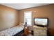 Cozy bedroom featuring a twin bed, window view, and TV on wicker chest at 6208 S 200 W, Trafalgar, IN 46181