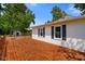 Spacious wood deck featuring dark blue shutters and a lush backyard at 6208 S 200 W, Trafalgar, IN 46181