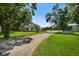 Charming home with a long gravel driveway, surrounded by lush greenery and mature trees at 6208 S 200 W, Trafalgar, IN 46181