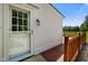 Side of home with white siding, wood deck, and green surroundings at 6208 S 200 W, Trafalgar, IN 46181