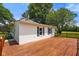 Exterior side view of home with wood deck, chimney and lush backyard at 6208 S 200 W, Trafalgar, IN 46181