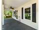 Charming front porch with a ceiling fan, swing, and views of the lush surroundings, ideal for outdoor relaxation at 6208 S 200 W, Trafalgar, IN 46181