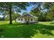Quaint home featuring a charming covered front porch, inviting landscaping, and a well-manicured lawn at 6208 S 200 W, Trafalgar, IN 46181