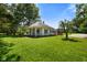 Charming home featuring a covered front porch, beautiful landscaping, and mature trees on a well-maintained lawn at 6208 S 200 W, Trafalgar, IN 46181