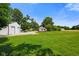 Expansive green yard with a large barn-style outbuilding on a sunny day, offering lots of space at 6208 S 200 W, Trafalgar, IN 46181