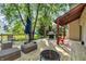 Spacious wooden deck featuring outdoor seating, a grill, and a cozy fire pit at 6374 Timberbluff Cir, Avon, IN 46123
